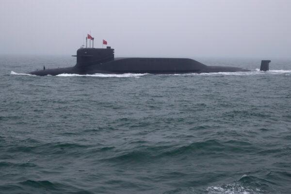 A Type 094 Jin-class nuclear submarine, Long March 15, participates in a naval parade to commemorate the 70th anniversary of the founding of China's navy in the sea near Qingdao, in eastern Shandong Province, China, on April 23, 2019. (Mark Schiefelbein/Pool/AFP/via Getty Images)