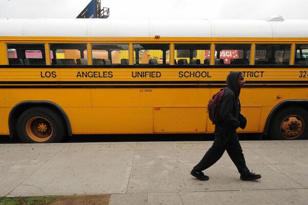 A student on his way to school walks past a Los Angeles Unified School District (LAUSD) school in Los Angeles on Feb. 13, 2009. (Robyn Beck/AFP via Getty Images)