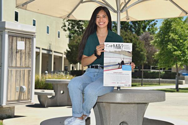 Student and plaintiff Juliette Colunga holds a flyer. (Courtesy of Alvarez Photography Studio)