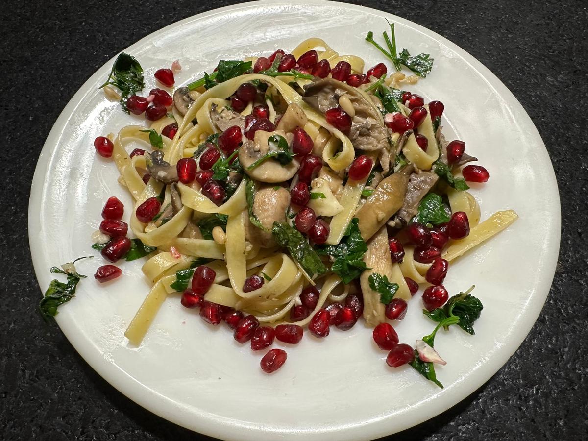 This mushroom and cheese pasta dish owes its magic in part to its garnish of pomegranate seeds, which electrify the dish. (Ari LeVaux)