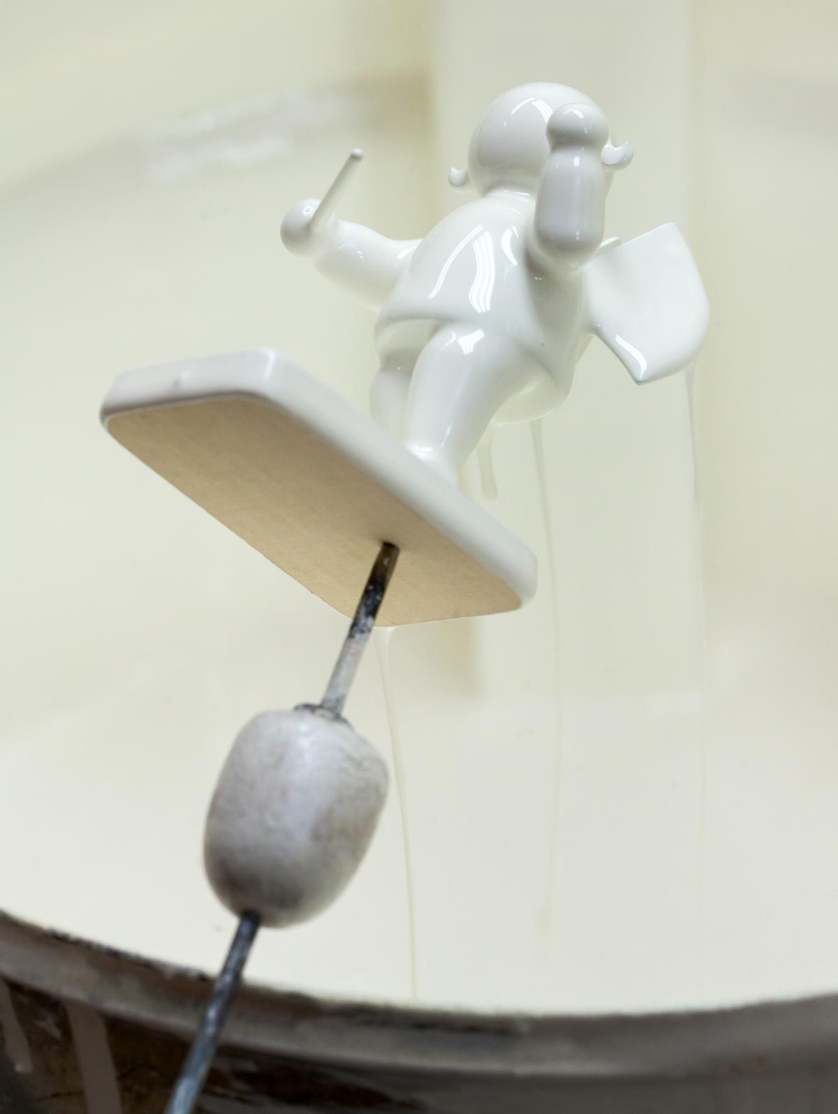 Each assembled wooden figurine is triple-dipped in white paint as a primer. (Courtesy of Wendt and Kuhn)