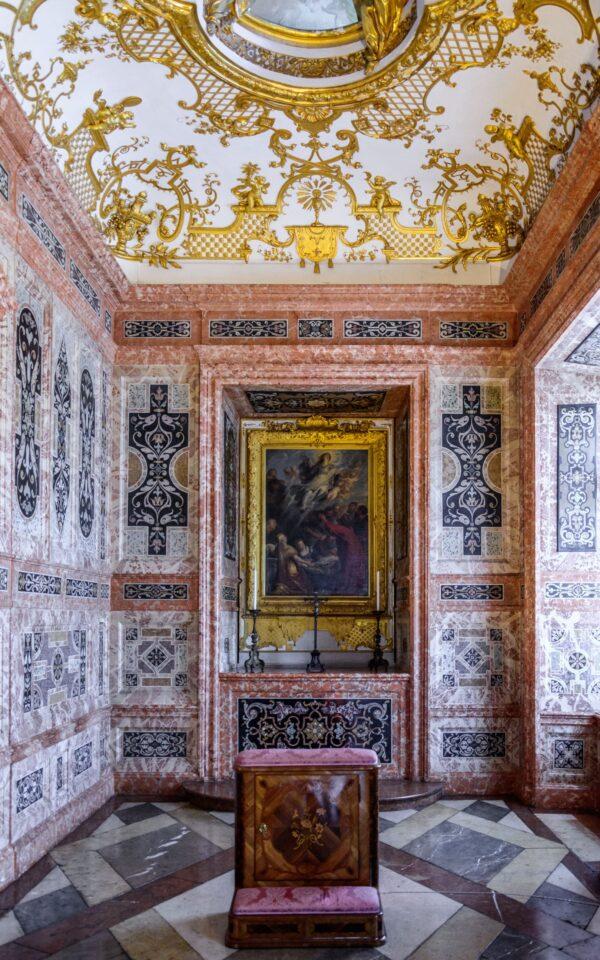 At the far end of the staterooms is the private chapel of Max Emanuel. It's covered with scagliola panels, a technique using stucco inlays to imitate marble, emphasizing the wealth of the prince-elector. (<a href="https://www.shutterstock.com/g/AESphoto">Andrey Shcherbukhi</a>/<a style="font-size: 16px;" href="anuel, new palace https://www.shutterstock.com/image-photo/munich-germany-05-may-2016-luxury-449730148">Shutterstock)</a>