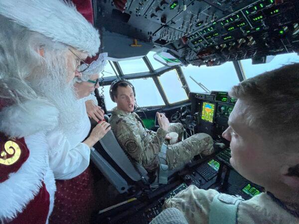 Santa and Mrs. Claus chat with the flight crew of an Alaska National Guard cargo plane while en route to Nuiqsut, Alaska, on Nov. 29, 2022. (Mark Thiessen/AP Photo)