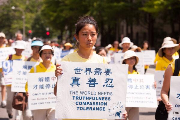 Falun Gong practitioners march in a parade calling for an end to the persecution in China, in Washington on July 17, 2014. (Larry Dye/The Epoch Times)