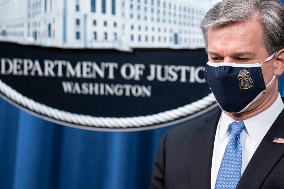 FBI Director Christopher Wray attends a virtual press conference at the Department of Justice in Washington on Oct. 28, 2020. Eight people have been arrested as part of "Operation Fox Hunt," an effort by the Chinese regime to threaten people to return to China. (Sarah Silbiger/Getty Images)