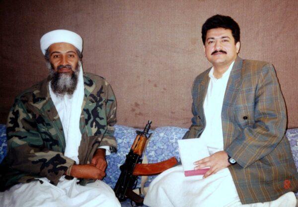 Saudi militant Osama bin Laden (L) sits with Pakistani journalist Hamid Mir during an interview at an undisclosed location in Afghanistan. (Visual News/Getty Images)