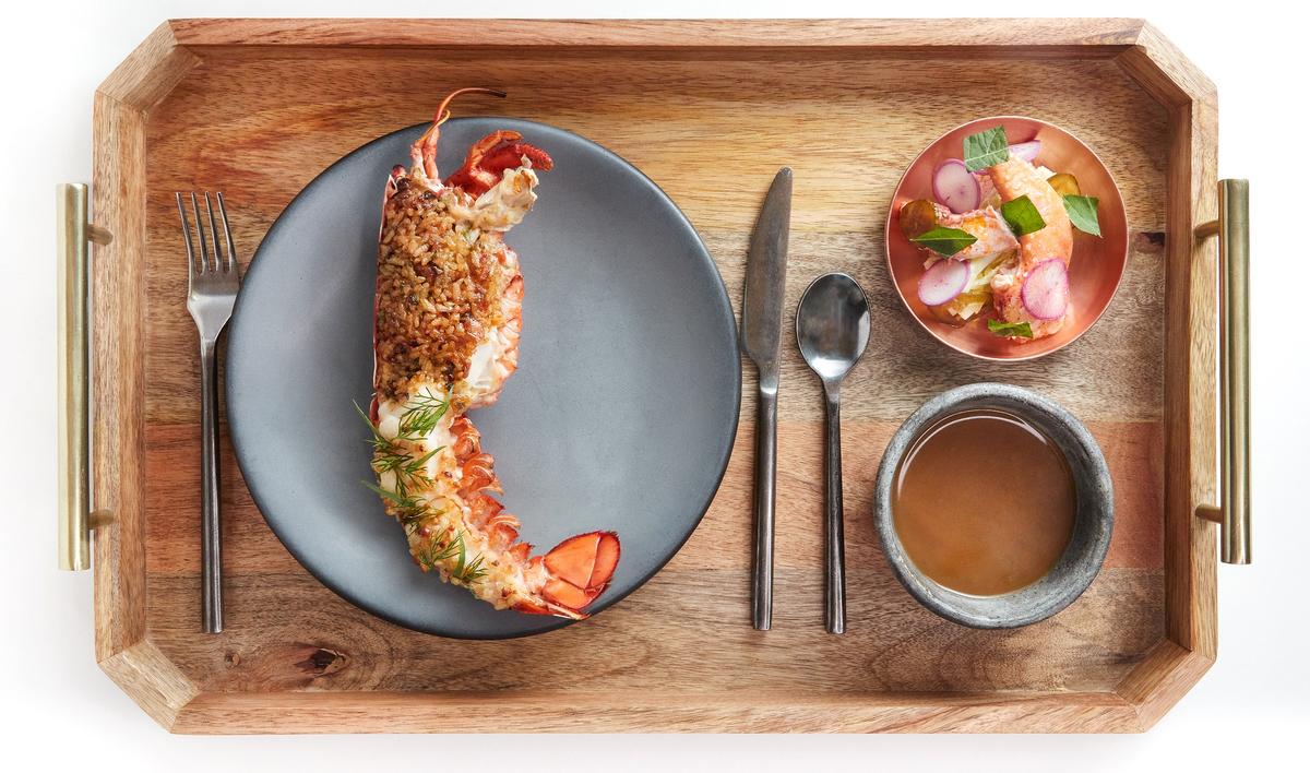 The lobster entree, brushed with pine nut-garlic butter and stuffed with tomalley fried rice, is a menu staple. (Moonhee Kim)