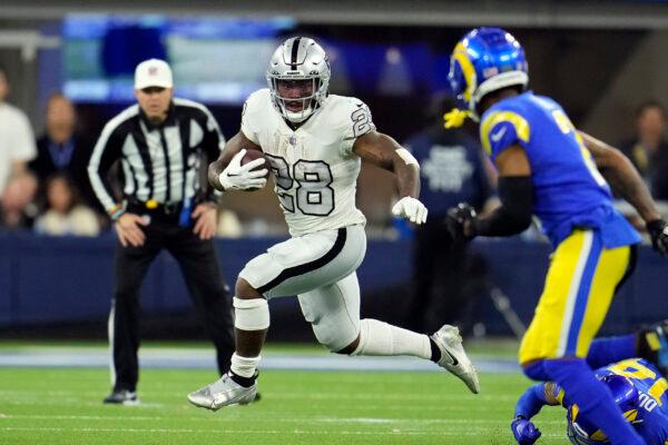 Las Vegas Raiders running back Josh Jacobs runs with the ball during the first half of an NFL football game against the Los Angeles Rams, in Inglewood, Calif., on Dec. 8, 2022. (Marcio Jose Sanchez/AP Photo)
