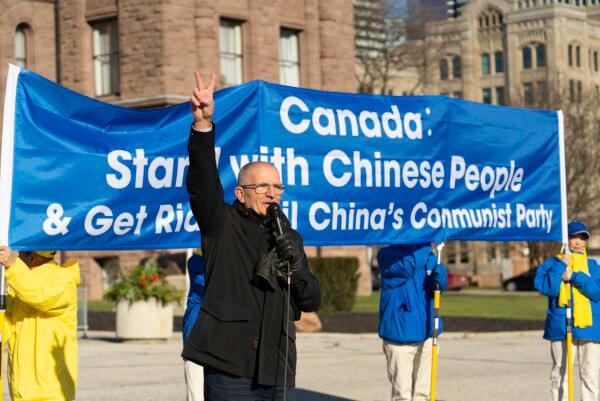 Former Conservative MP Wladslaw Lizon gestures a sign of victory on Dec. 8, 2022, in Queens's Park, Toronto, where he addresses a group of demonstrators who were voicing support for a bill banning forced organ harvesting. (Evan Ning/The Epoch Times)