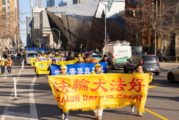 Hundreds of Falun Gong adherents marched in a parade across downtown Toronto, on Dec. 8, to protest the Chinese Communist regime's forced organ harvesting and to support a bill aimed at banning the crime. (Evan Ning/The Epoch Times)