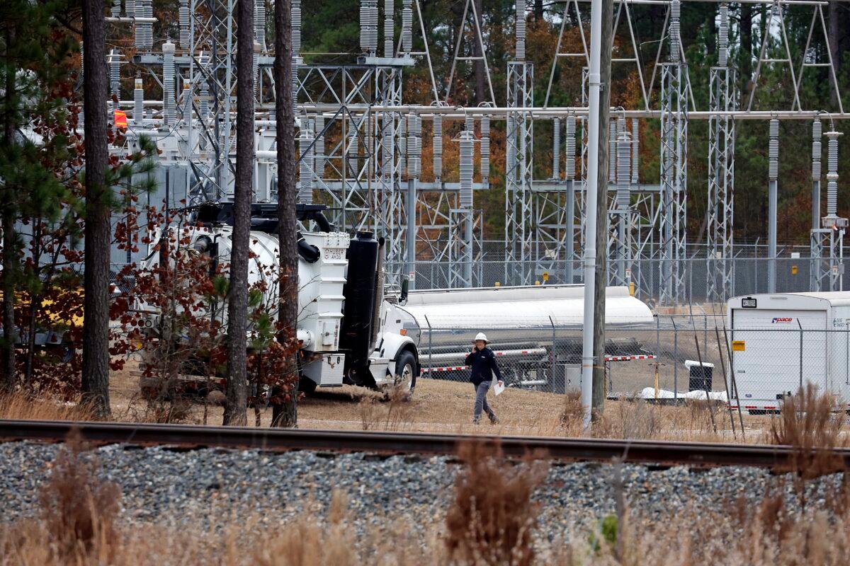 Workers work on equipment at the West End Substation in West End, N.C., on Dec. 5, 2022, where a serious attack on critical infrastructure caused a power outage to many around Southern Pines, N.C. (Karl B DeBlaker/AP Photo)