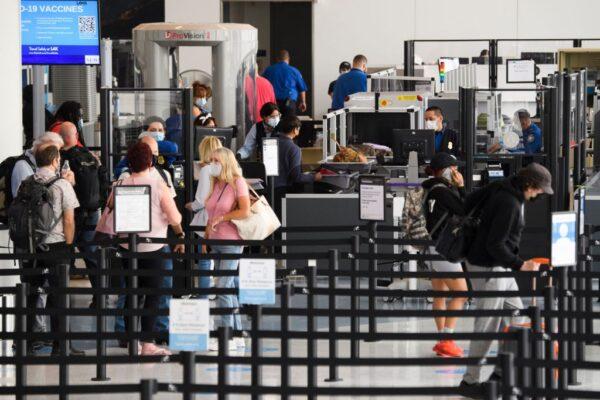 Travelers enter a new Transportation Security Administration (TSA) screening area during the opening of the Terminal 1 expansion at Los Angeles International Airport (LAX) in Los Angeles, on June 4, 2021. (Photo by Patrick T. Fallon/AFP via Getty Images)