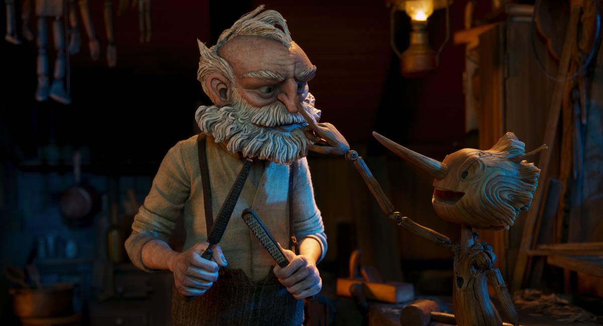 Widower-woodcarver Geppetto (voiced by David Bradley) and his creation, the wooden boy Pinocchio (voiced by Gregory Mann), in Guillermo del Toro's "Pinocchio." (Netflix)