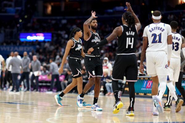Paul George (13) of the Los Angeles Clippers celebrates after scoring with teammate Terance Mann (14) against the Washington Wizards in the second half at Capital One Arena in Washington, on Dec. 10, 2022. (Rob Carr/Getty Images)