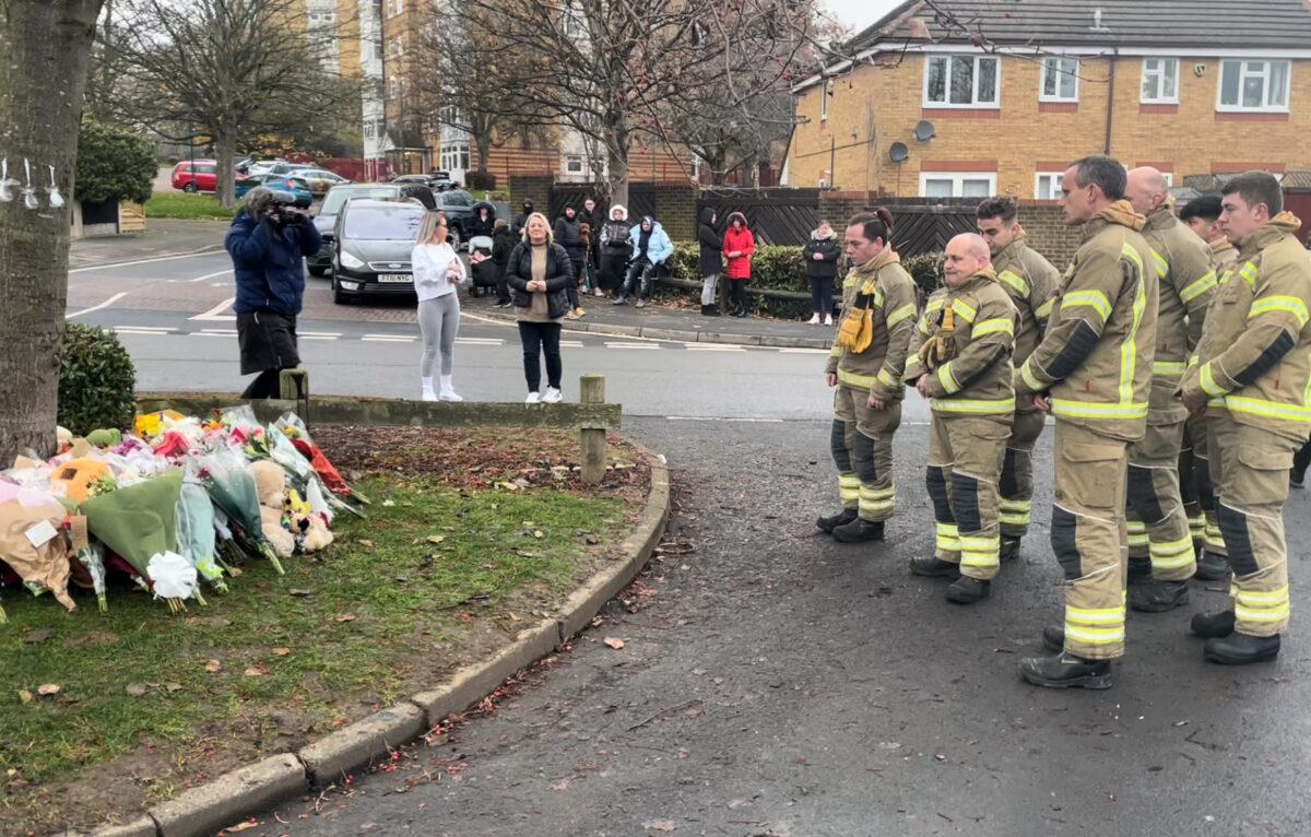 Firefighters pay tribute to three boys who died after falling through ice into a lake at Kingshurst, near Birmingham, England, on Dec. 12, 2022. (PA)