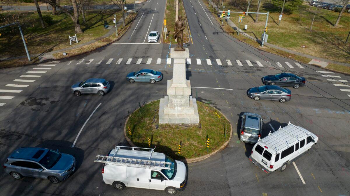 Traffic drives in the circle at the monument of confederate General A.P. Hill, which contains his remains, in the middle of a traffic circle on Arthur Ashe Blvd. in Richmond, Va., on Jan. 6, 2022. (Steve Helber/AP Photo)