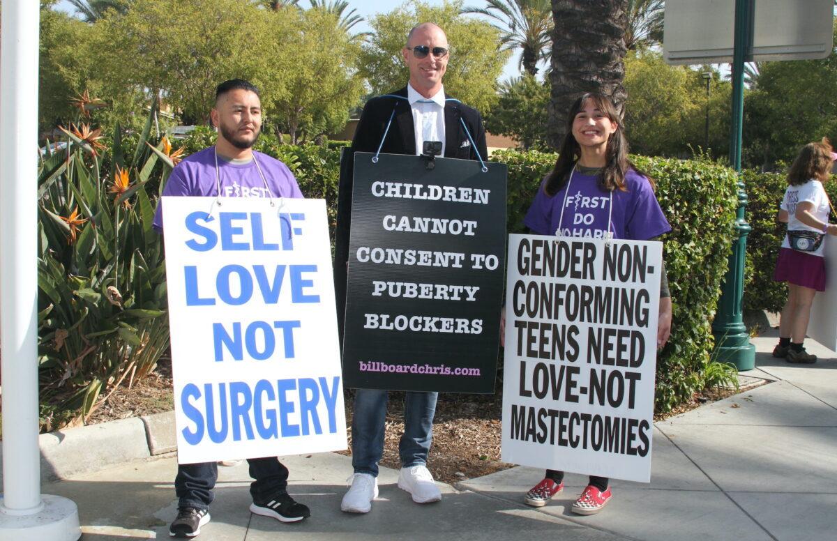 Abel Garcia, Billboard Chris, and Chloe Cole take part in a demonstration in Anaheim, Calif., on Oct. 8, 2022. (Brad Jones/The Epoch Times)