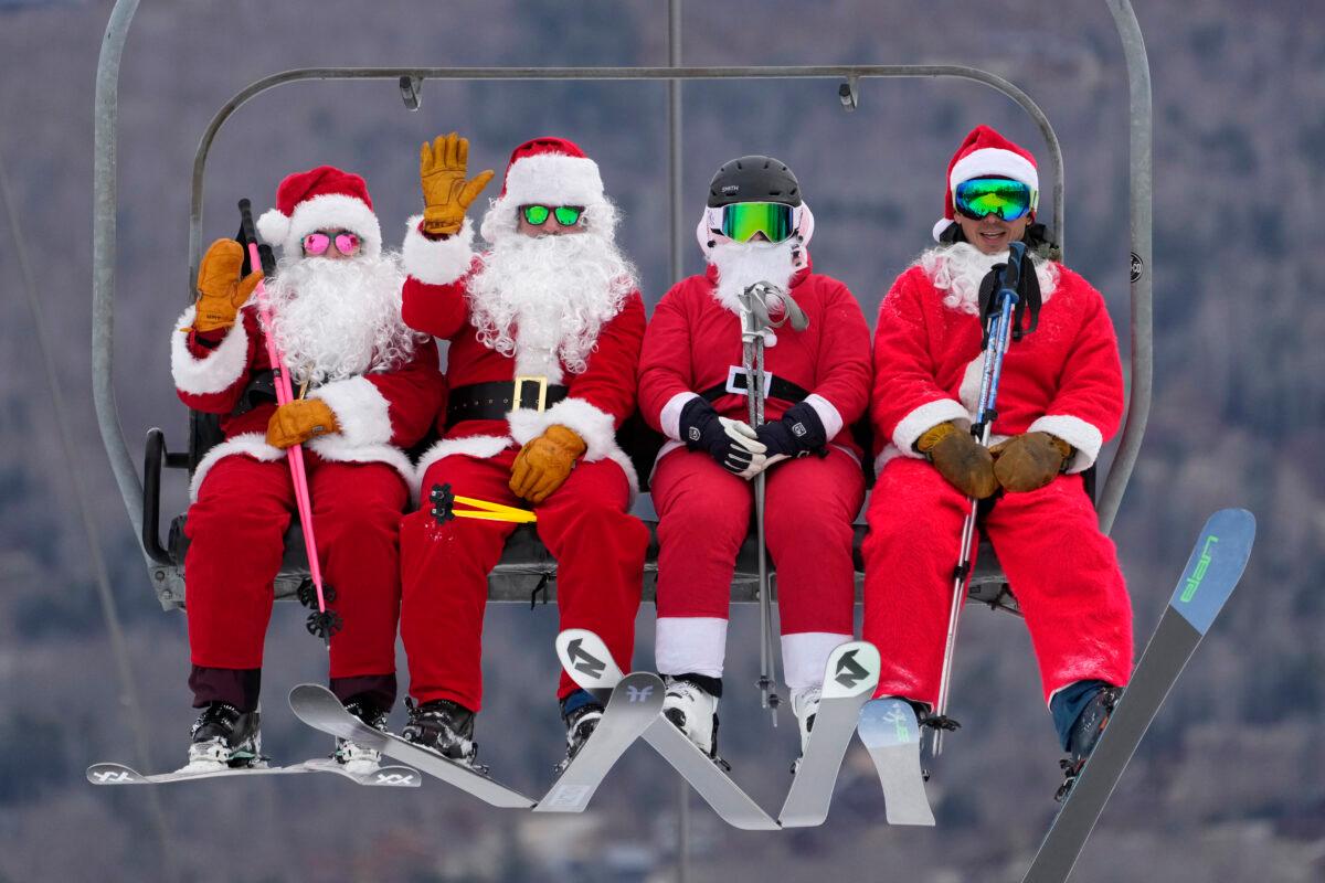 Skiers dressed in Santa Claus outfits ride a chairlift at the Sunday River Ski Resort in Newry, Maine, on Dec. 11, 2022. (Robert F. Bukaty/AP Photo)