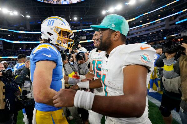 Los Angeles Chargers quarterback Justin Herbert (10) shakes hands with Miami Dolphins quarterback Tua Tagovailoa after an NFL football game in Inglewood, Calif., on Dec. 11, 2022. (Jae C. Hong/AP Photo)