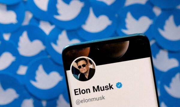 Elon Musk's Twitter profile on a smartphone placed on printed Twitter logos on April 28, 2022. (Dado Ruvic/Illustration/Reuters)