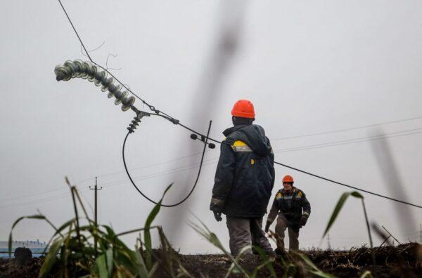 Workers repair high-voltage power lines cut by recent missile strikes near Odesa on Dec. 7, 2022, amid the Russian invasion of Ukraine. (Oleksandr Gimanov/AFP via Getty Images)