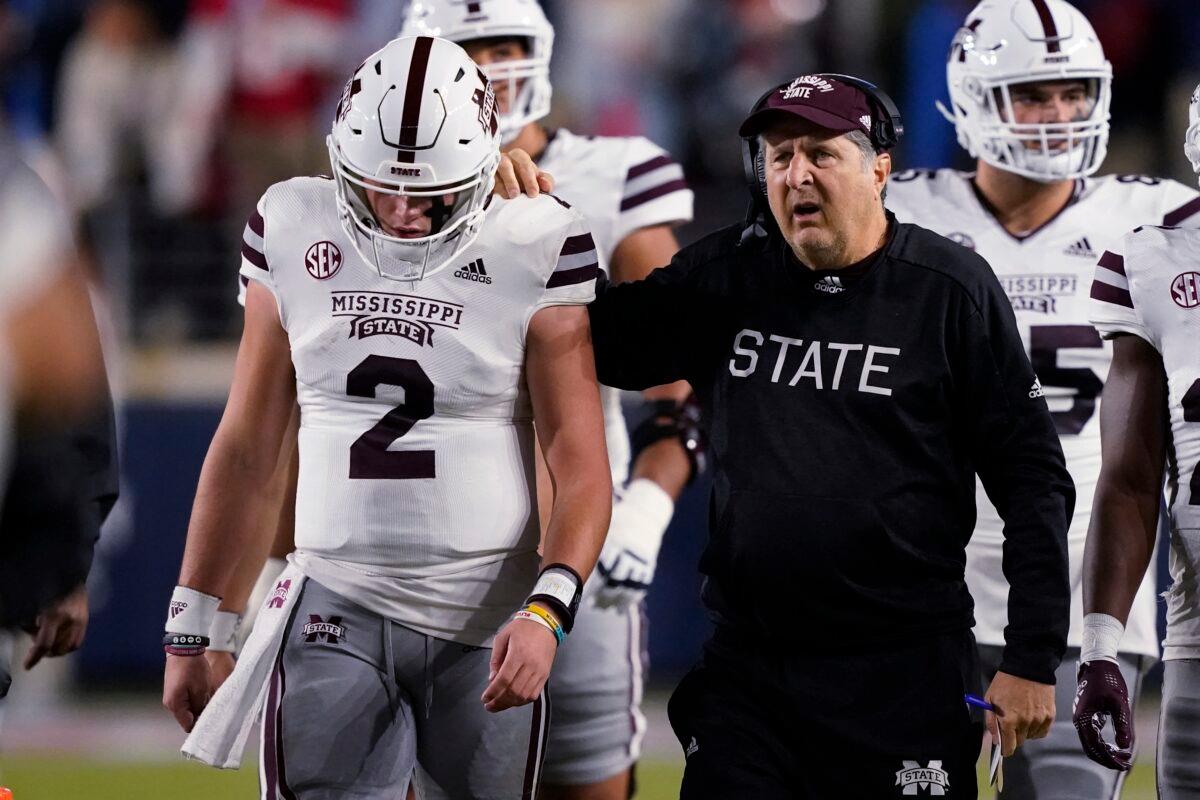 Mississippi State coach Mike Leach confers with quarterback Will Rogers (2) during the first half of the team's NCAA college football game against Mississippi in Oxford, Miss., on Nov. 24, 2022. (Rogelio V. Solis/AP Photo)