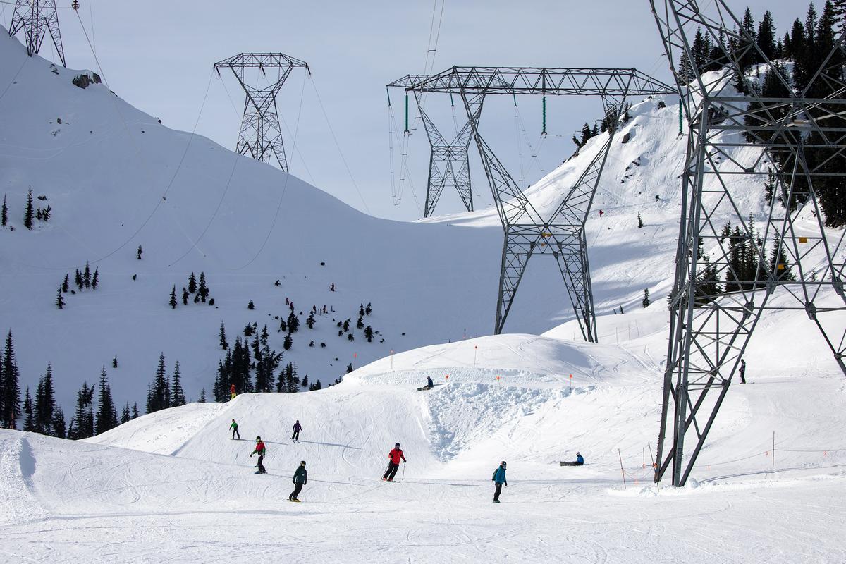 Skiers and snowboarders come down Gemini under the power lines on the back side of the mountain Friday, Jan. 28, 2022, at Stevens Pass, Washington. (Jennifer Buchanan/The Seattle Times/TNS)
