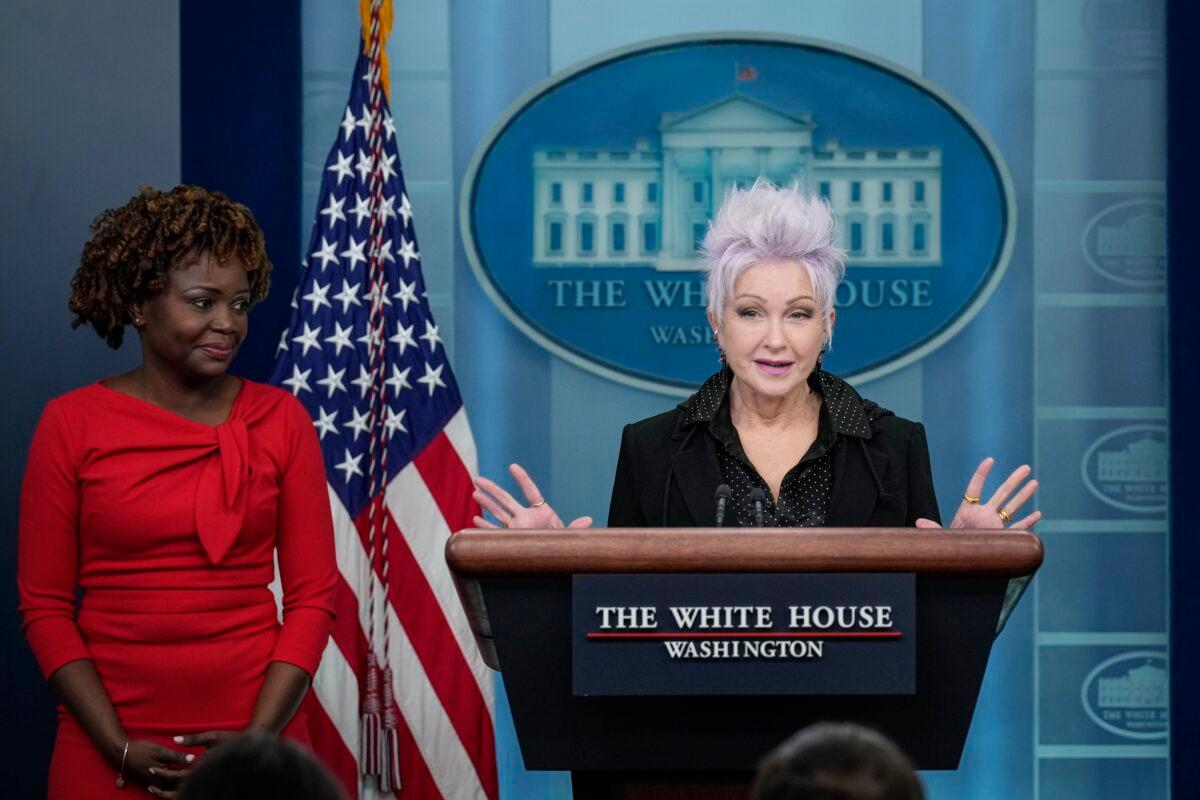 White House press secretary Karine Jean-Pierre looks on as singer Cyndi Lauper speaks during a briefing at the White House in Washington on Dec. 13, 2022. (Drew Angerer/Getty Images)