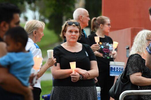 Local community members participate in a vigil at Calamvale police station, Calamvale, south of Brisbane, Queensland, in Australia on Dec. 13, 2022. Constables Matthew Arnold, 26, and Rachel McCrow, 29, died in an ambush and siege at a remote Queensland property. (AAP Image/Jono Searle)