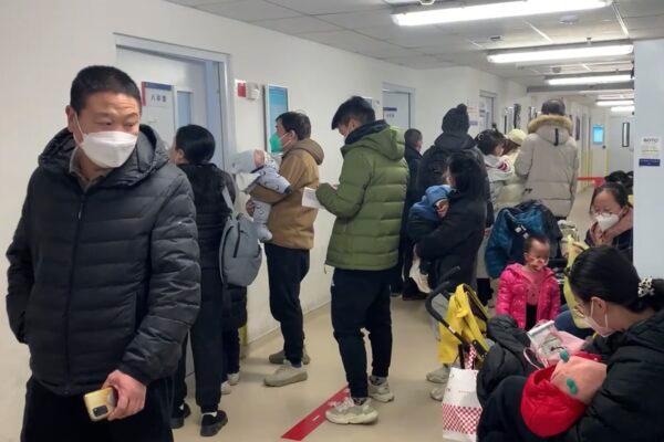 Visitors wear masks at the children's hospital in Beijing on Dec. 14, 2022. (Dake Kang/AP Photo)