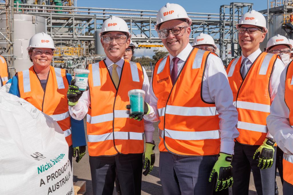 Australian Prime Minister Anthony Albanese (C), Japanese Prime Minister Fumio Kishida—and BHP CEO Mike Henry (R)—hold jars of nickel sulphate during a visit to the BHP Nickel West Kwinana Nickel Refinery in Perth, Australia on Oct. 22, 2022. (Richard Wainwright - Pool/Getty Images)