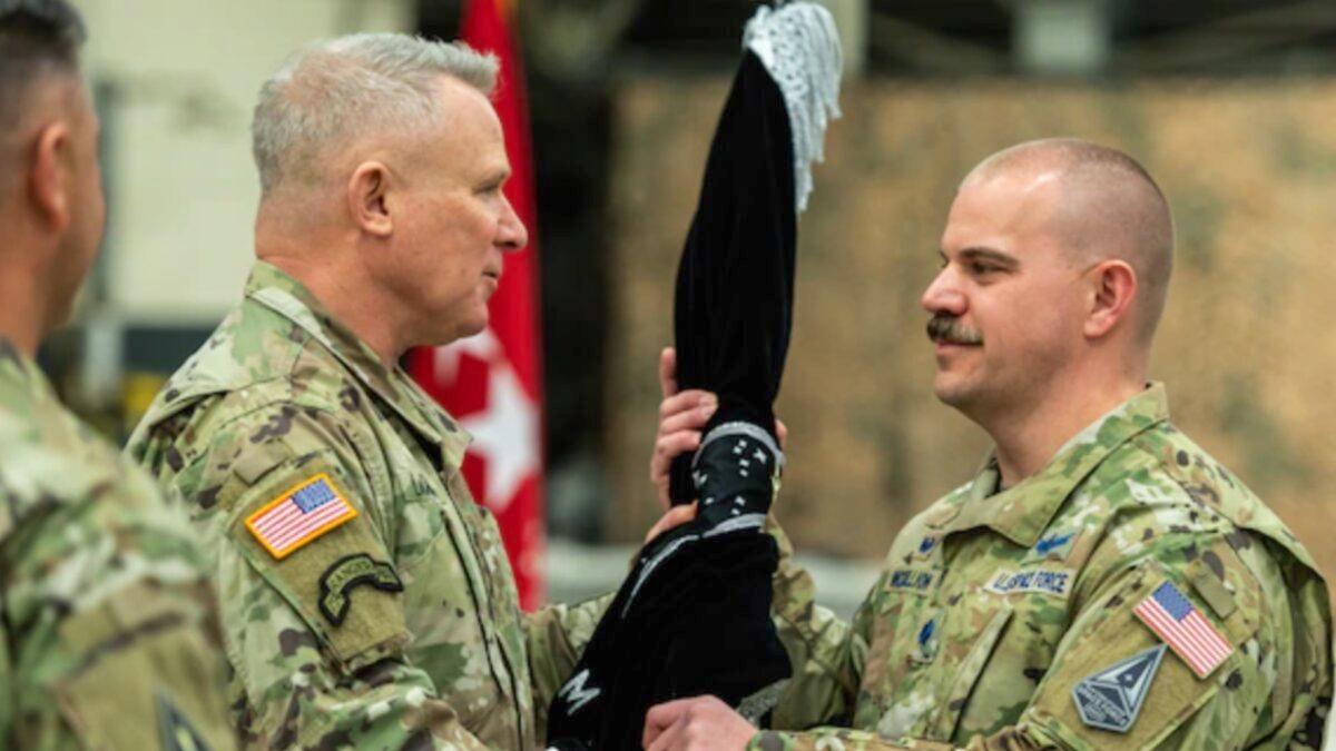 U.S. Army Gen. Paul LaCamera (R) passes the U.S. Space Forces Korea (USSFK) guidon to U.S. Space Force (USSF) Lt. Col. Joshua McCullion (L), USSFK inaugural commander, during the unit’s activation ceremony at Osan Air Base, Republic of Korea, on Dec. 14, 2022. (Courtesy of Staff Sgt. Skyler Combs via U.S. Space Forces Korea)