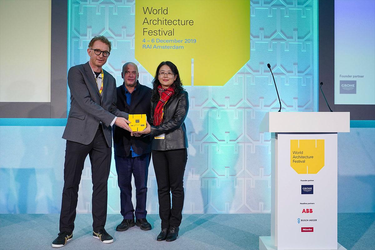 Prof. Peter W. Ferretto, Associate Professor at CUHK School of Architecture (left), and Prof. Cai Ling, Associate Professor at GZU School of Architecture and Urban Planning (right), receiving an award at the World Architecture Festival in Amsterdam, Netherlands on Dec. 2, 2022. (Courtesy of World Architecture Festival)