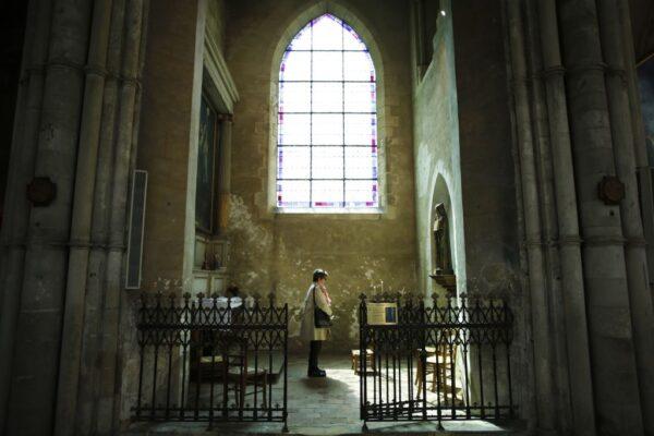 A woman prays at the cathedral of Lisieux, northwestern France, on May 15, 2018. (Charly Triballeau/AFP via Getty Images)