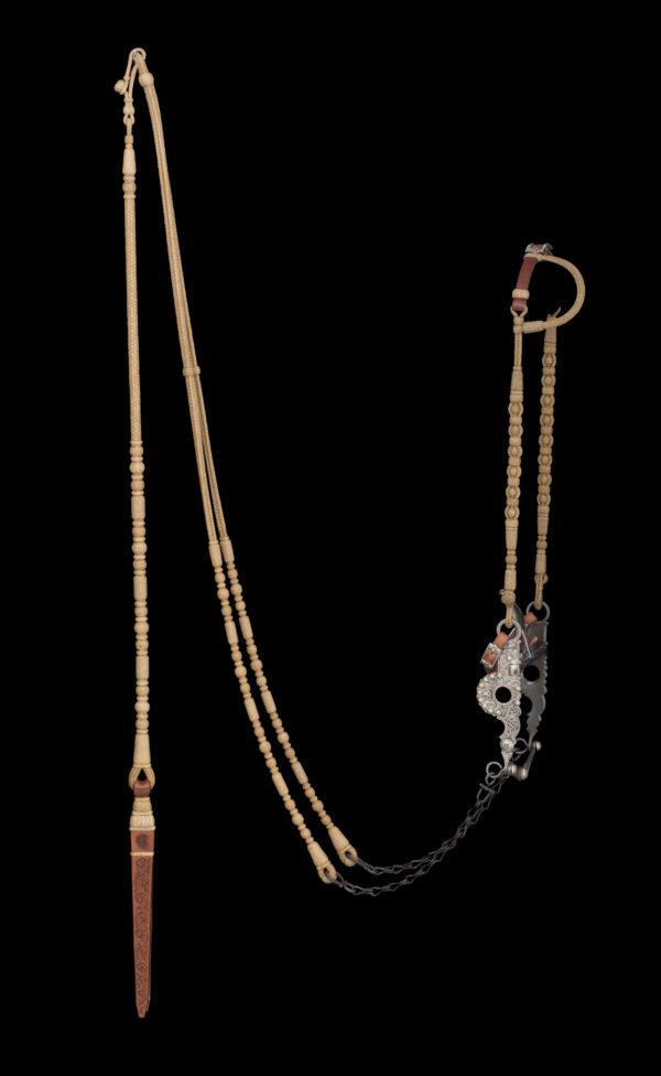 A bridle set by rawhide braider Jay Adcock. Corriente-yearling rawhide and 178 rawhide buttons. Curb strap by Cary Schwarz. Silver buckle by Beau Compton. Santa Barbara-style spade bit by Ernie Marsh. Popper by saddler Pedro Pedrini. (National Cowboy & Western Heritage Museum)