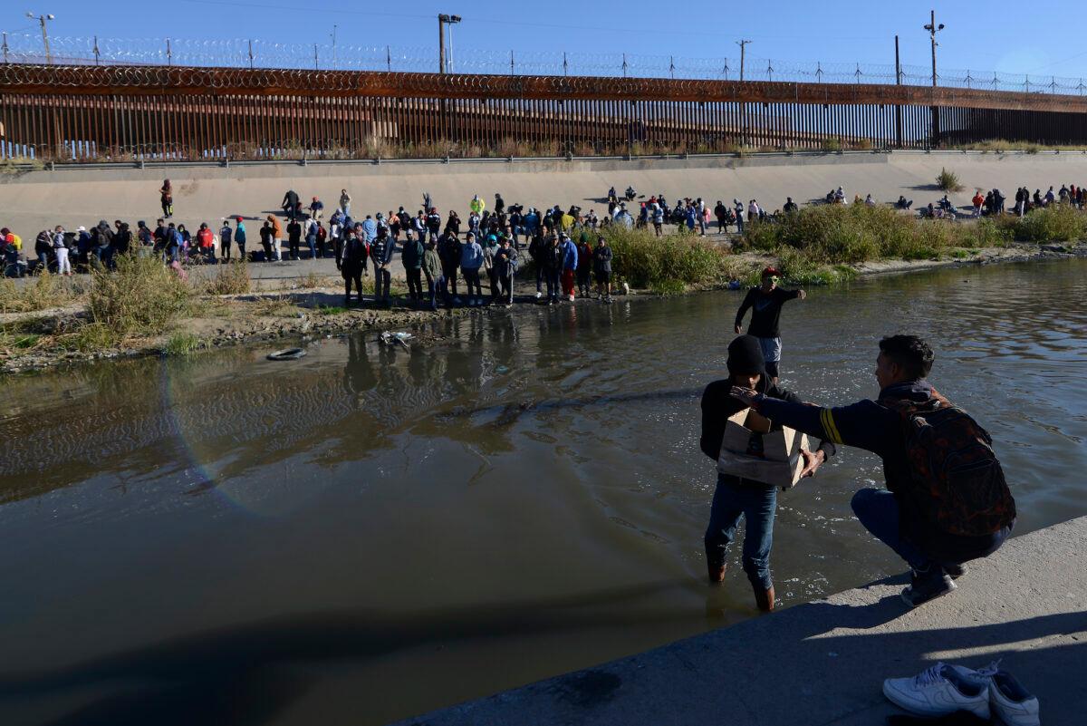 Illegal immigrants cross the Mexico-U.S. border to surrender to U.S. Border Patrol agents, in Ciudad Juarez, Mexico, on Dec. 12, 2022. (AP Photo/Christian Chavez)