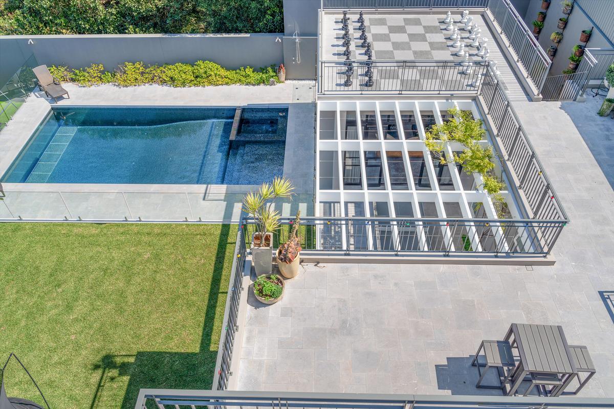 An overhead view of the pool, adjacent pavilion, and the life-size chess board. (Sydney Sotheby’s International Realty)