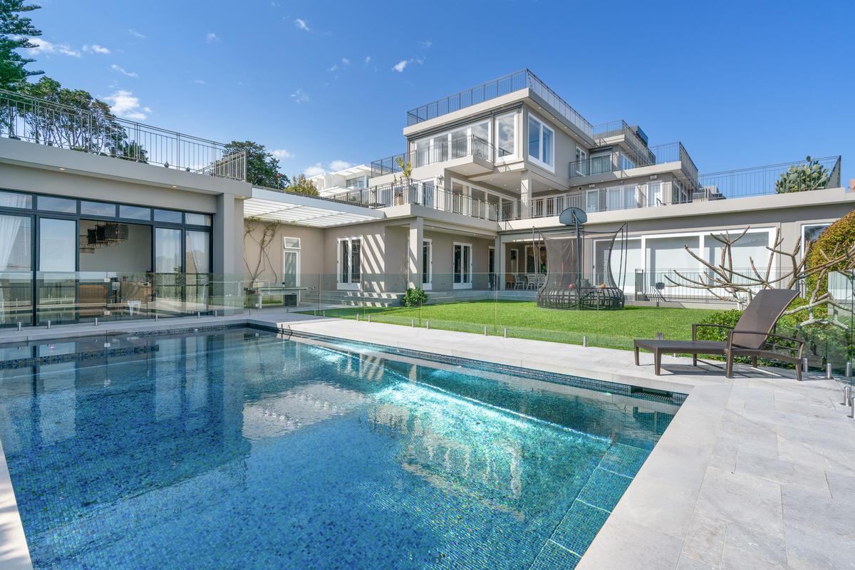 The property features resort-style amenities of a large pool, open common areas, rooftop al fresco dining areas, and outdoors game areas. (Sydney Sotheby’s International Realty)