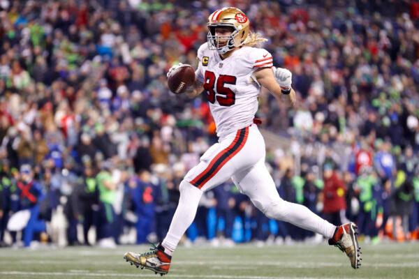 George Kittle (85) of the San Francisco 49ers carries the ball for a touchdown against the Seattle Seahawks during the third quarter of the game at Lumen Field in Seattle, on Dec. 15, 2022. (Steph Chambers/Getty Images)