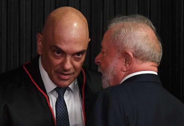 Brazilian presidential candidate for the leftist Workers Party (PT) and former President (2003-2010), Luiz Inácio Lula da Silva (R), greets Brazilian judge Alexandre de Moraes after he took over as head of the Superior Electoral Tribunal, at the TSE headquarters in Brasilia on Aug. 16, 2022. (Evaristo Sa/AFP via Getty Images)