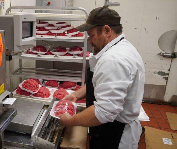 Meat department manager Jed Matthews at Jeff's Marketplace in Lexington, Michigan, on Dec. 14, 2022. (Steven Kovac/Epoch Times)