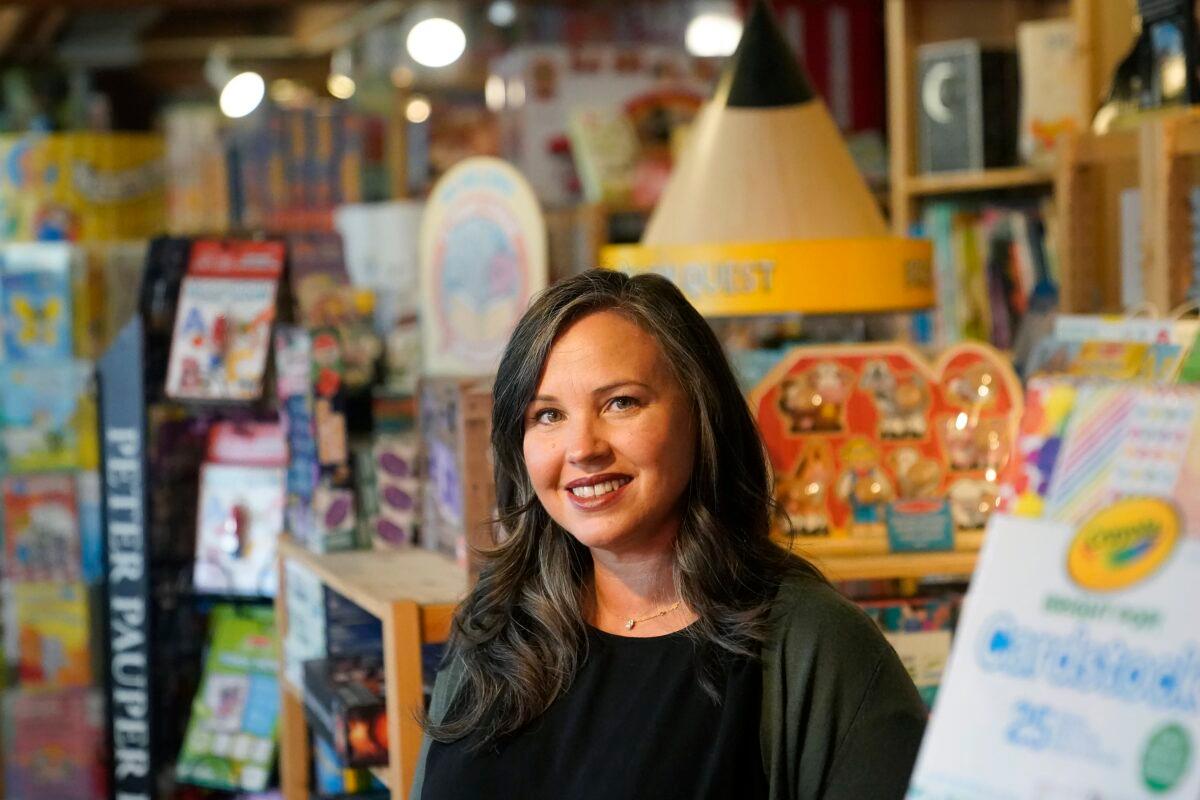Stephanie Sala, owner of Five Little Monkeys, smiles while interviewed at her store in Berkeley, Calif., on Dec. 12, 2022. (Jeff Chiu/AP Photo)