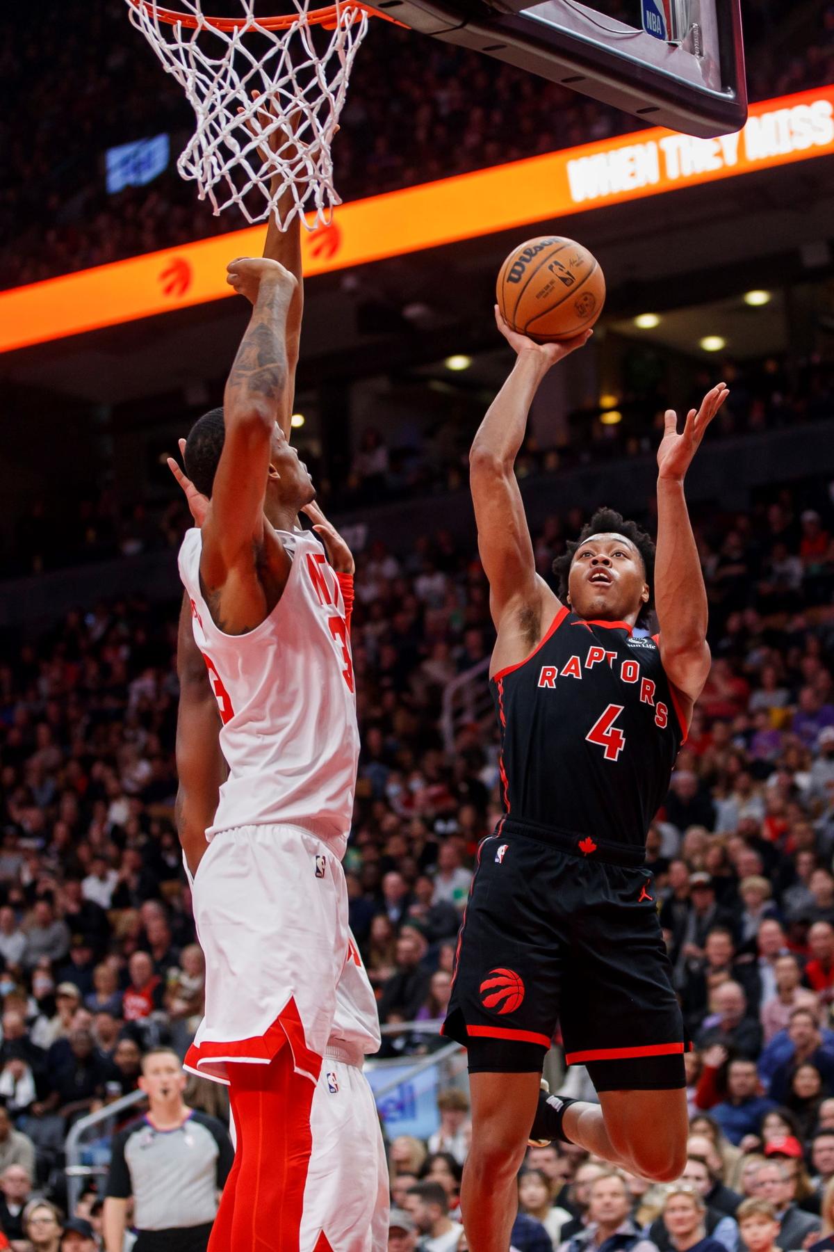 Toronto Raptors forward Scottie Barnes (4) shoots over Brooklyn Nets center Nic Claxton (33) during the first half of an NBA basketball game in Toronto, on Dec. 16, 2022. (Cole Burston/The Canadian Press via AP)