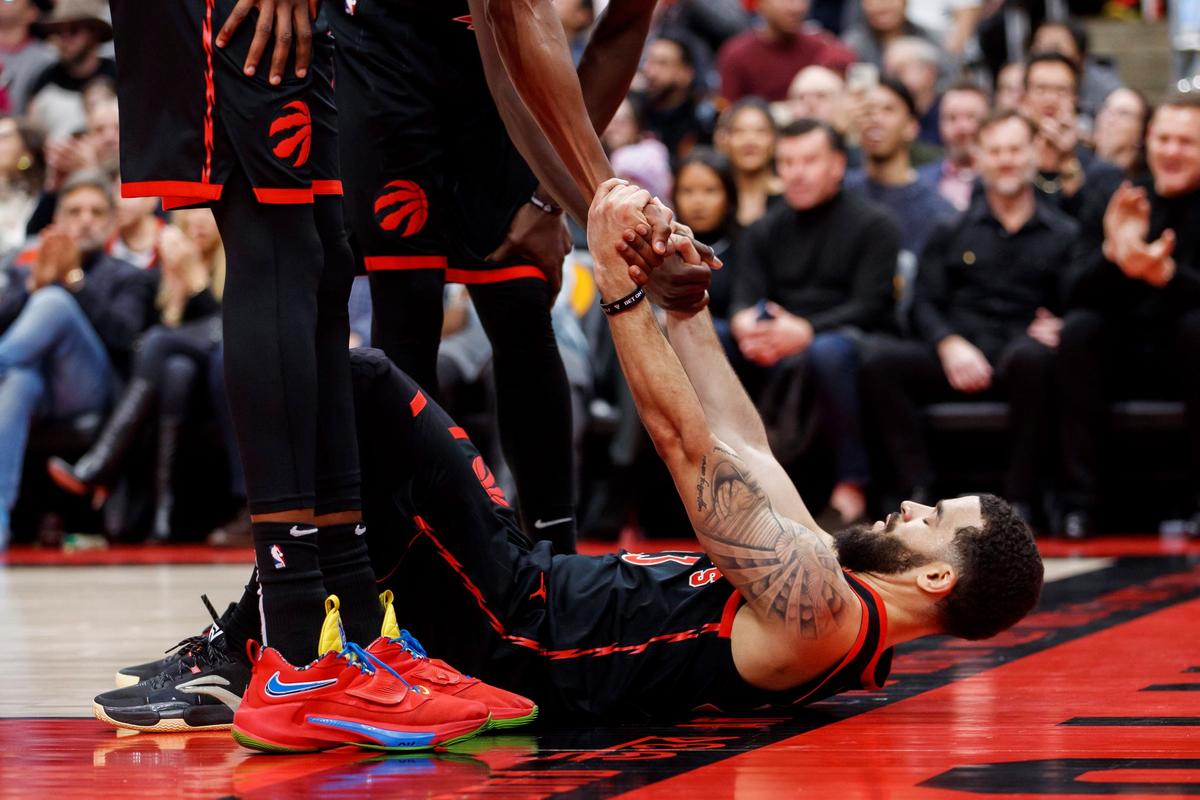Toronto Raptors guard Fred VanVleet (23) is picked up by teammates during the first half of an NBA basketball game against the Brooklyn Nets in Toronto, on Dec. 16, 2022. (Cole Burston/The Canadian Press via AP)