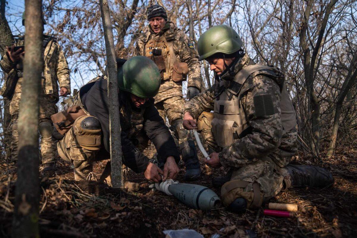 Ukrainian soldiers from the 68th brigade prepare a 120mm round to fire from a mortar launcher at a position along the front line in the Donetsk region on Dec. 9, 2022, amid the Russian invasion of Ukraine. (Ihor Tkachov/AFP via Getty Images)