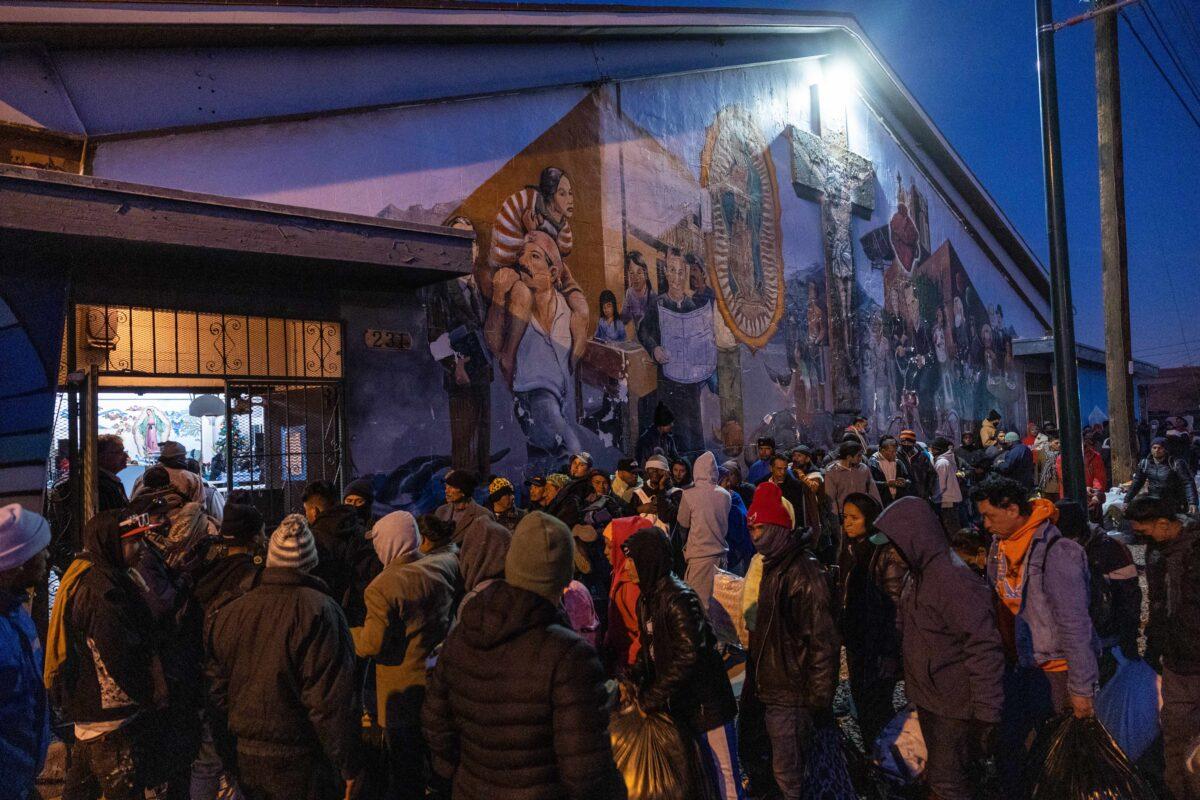 Illegal immigrants gather to enter a shelter at the Sacred Heart Church in El Paso, Texas, on Dec. 17, 2022. (John Moore/Getty Images)