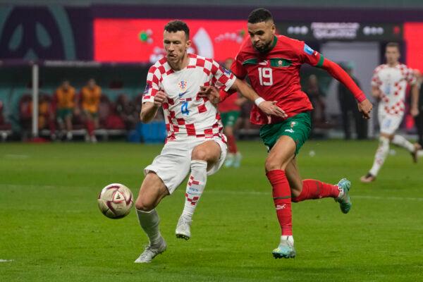 Croatia's Ivan Perisic, left, and /mo19, fight for the ball during the World Cup third-place playoff soccer match between Croatia and Morocco at Khalifa International Stadium in Doha, Qatar, on Dec. 17, 2022. (Thanassis Stavrakis/AP Photo)