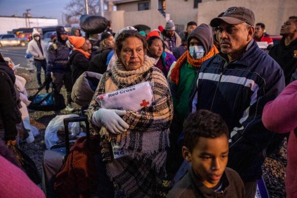 Illegal aliens wait to enter a shelter at the Sacred Heart Church in El Paso, Texas, on Dec. 17, 2022. (John Moore/Getty Images)