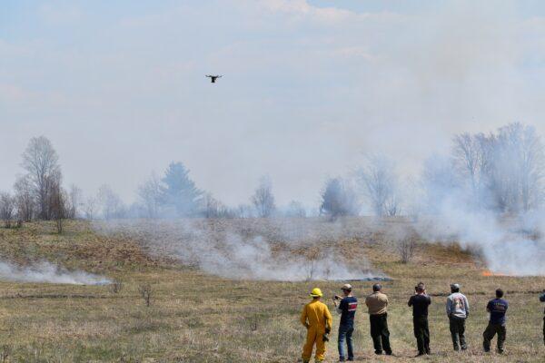 People observe a firefighting drone. (Drone Amplified)