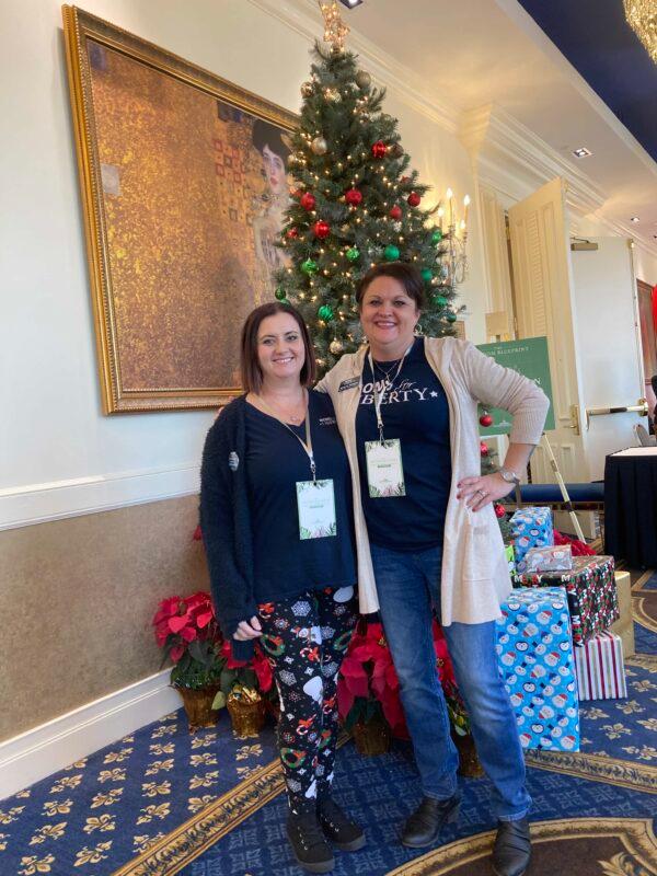 Moms for Liberty members Claudette O’Dowd (L) and Shannon Rambow (R), both from Flagler County, Fla., pose after listening to Gov. Ron DeSantis speak about successes that he and Republican school board candidates enjoyed in the November 2022 general election. The program was held at the Westgate Lakes Resort & Spa in Orlando, Fla., on Dec. 19, 2022. (John Haughey/The Epoch Times)